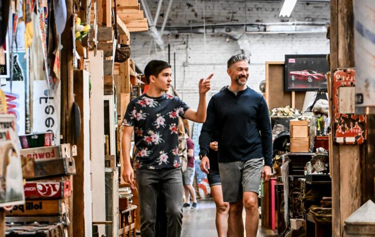 family walks through aisles inside antique mall